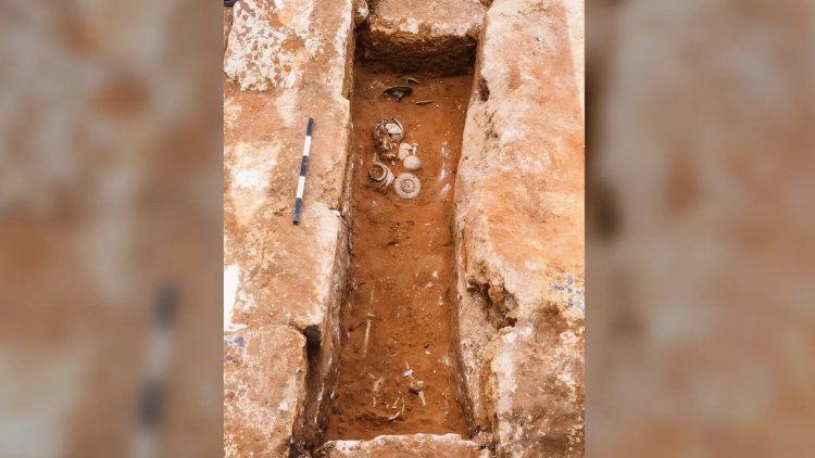 ערימת הממצאים בקצה הקבר, לצד כלי זכוכית מהתקופה הרומית. צילום: אסף פרץ, רשות העתיקות